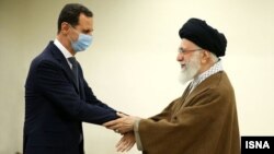 Syrian President Bashar al-Assad (left) greets Supreme Leader Ayatollah Ali Khamenei in Tehran on May 8.