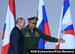 Russian President Vladimir Putin (left) and Defense Minister Sergei Shoigu on August 23, 2021. "[Shoigu is] still very popular and widely respected, despite the fact that he has no military background and no military training, and despite all these big failures [since] February [in Ukraine]," Soldatov says.