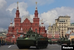 Russian BMD-4M infantry fighting vehicles and BTR-MDM armored personnel carriers drive on Red Square during the Victory Day parade.