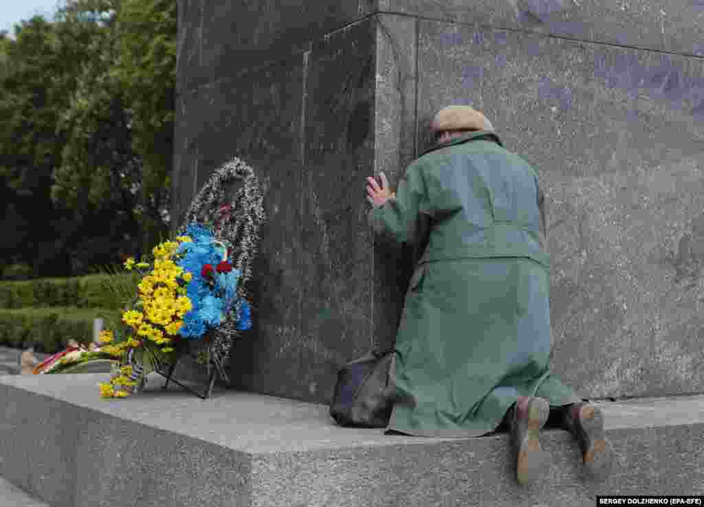 An elderly woman reacts near the Tomb of the Unknown Soldier during Victory Day celebrations in Kyiv on May 9.