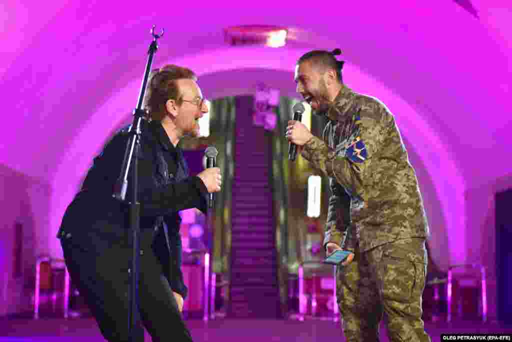 Irish musician Bono (left) of the band U2 performs with Ukrainian singer Taras Topolya from the band Antytila, who now serves in the Ukrainian Army, in the Khreshatyk metro station in Kyiv on May 8.