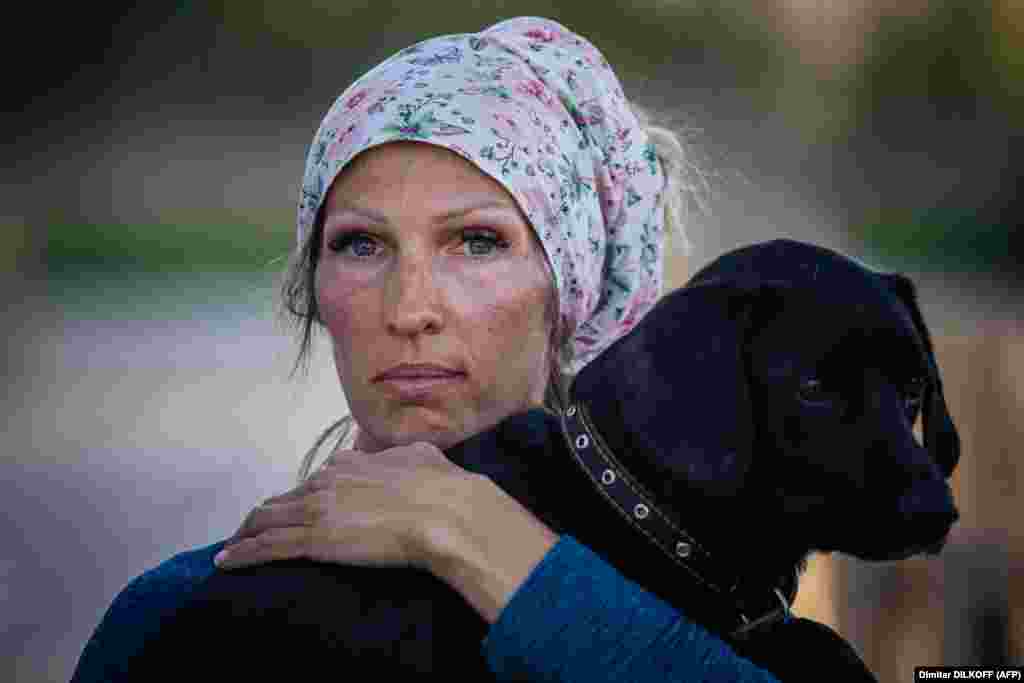 A woman holds her dog after arriving from Russian-occupied territory at a registration and processing area for internally displaced people in Zaporizhzhya, Ukraine.