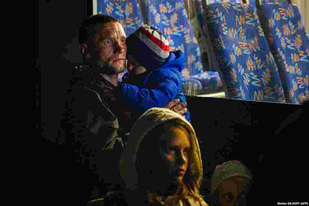 A man and his children arrive from Mariupol at a registration and processing area for internally displaced people in Zaporizhzhya, Ukraine.