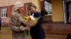 U.S. first lady Jill Biden (left) receives flowers from Olena Zelenska, wife of Ukraine's President Volodymyr Zelenskiy, outside a public school in Uzhhorod, Ukraine, on May 8.