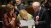 EU High Representative for Foreign Affairs and Security Policy Catherine Ashton, German Chancellor Angela Merkel, and European Council President Herman Van Rompuy (left to right) talk prior to the roundtable meeting in Brussels on June 28.