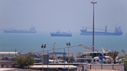 Shipping vessels lie off the Iranian port of Bandar Abbas along the Strait of Hormuz on June 18.