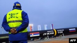 A construction worker stands in front of two giant pipes arranged to be welded together near the village of Sajkas, 80 kilometres north of the Serbian capital Belgrade late last year.