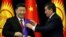 Kyrgyz President Sooronbai Jeenbekov (right) awards Chinese President Xi Jinping with the Manas Order at a meeting in Bishkek in June 2019. 