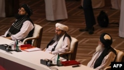 Members of the Taliban delegation attend the opening session of the peace talks with the Afghan government in Doha on September 12.