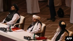 Members of the Taliban delegation at the opening session of peace talks between the Afghan government and the Taliban in Doha.