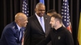 US Chairman of the Joint Chiefs of Staff General Charles Q. Brown (L) and Ukraine's President Volodymyr Zelensky shake hands under the eyes of , US Secretary of Defence Lloyd Austin (C) at the start of a Ukraine Defence Contact Group meeting on September 