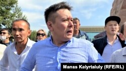 Zhanbolat Mamai talks to a reporter at a Democratic Party rally in Almaty in September 2021.