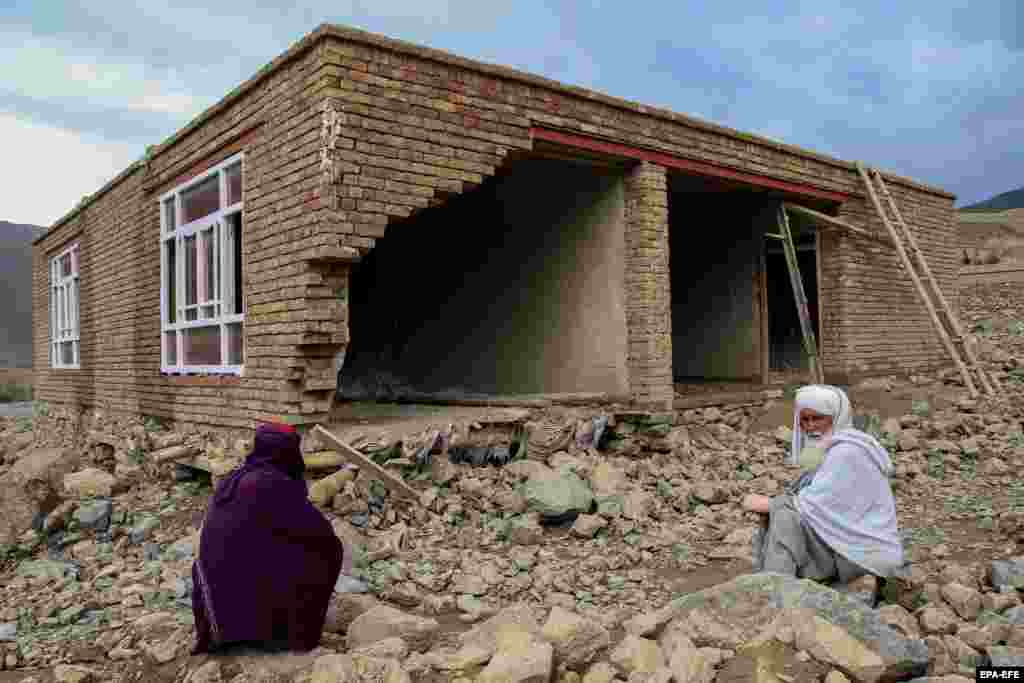 People salvage their belongings from houses damaged in flash floods in Parwan Province, Afghanistan.&nbsp;