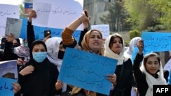 In March 2022, Afghan women and girls shout slogans demanding the reopening of high schools for girls during a demonstration in front of the Ministry of Education in Kabul. 