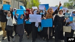 Afghan women and girls protest in Kabul after the Taliban decided in March to keep girls' secondary schools closed.