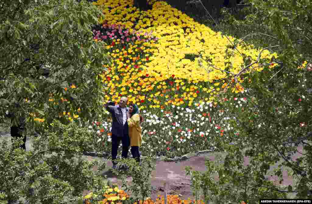 An Iranian couple visits the Asara tulip exhibition in the city of Asara, Alborz Province.