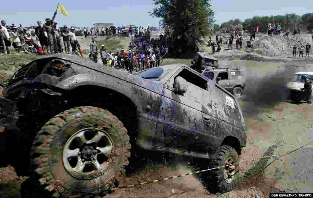 Drivers steer their all-terrain vehicles through a mud pit during the Jeep Sprint Festival in the village of Ozernoe, Kyrgyzstan.