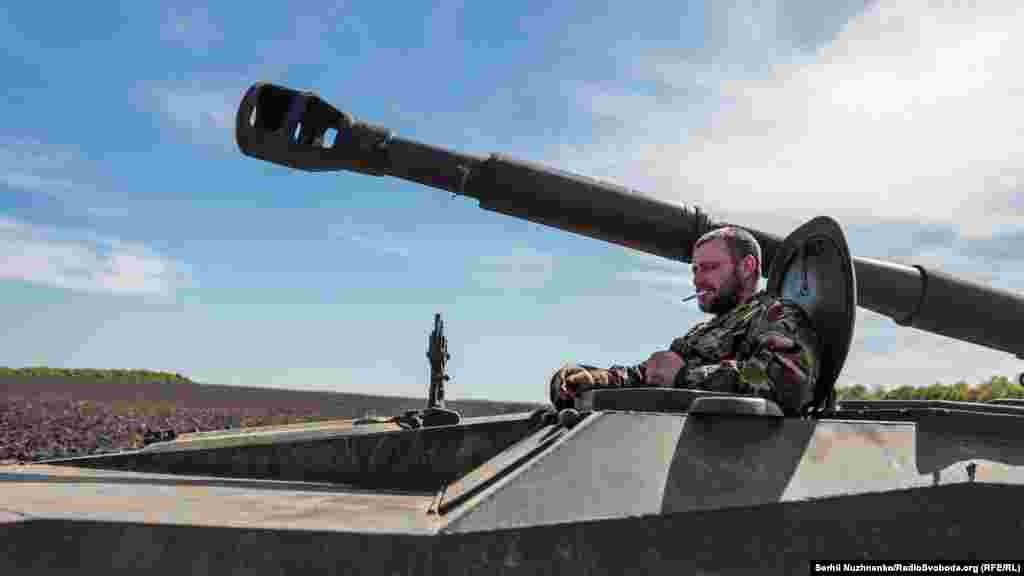 Украинский военный курит, сидя в 122-мм самоходной артиллерийской установке 2С1 &laquo;Гвоздика&raquo;, Харьковщина, 7 мая 2022 года