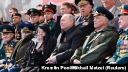 Russian President Vladimir Putin (center) watches a military parade marking the 77th anniversary of the Soviet Union's contribution to victory over Nazi Germany in World War II, in Red Square on May 9.