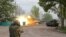 Moscow-backed separatist troops fire from a tank during fighting near the Azovstal steel plant in the southern port city of Mariupol on May 5.