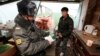 A Russian police officer checks the documents of a Kyrgyz migrant worker. (file photo)