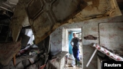 Russia -- A local resident looks at the debris of a house damaged by floods in the town of Krymsk in Krasnodar region, 08Jul2012