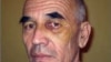 Правозащитник Азимжан Аскаров во время следствия со следами побоев на лице.