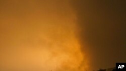The sky over Tripoli is illuminated by explosions during an airstrike