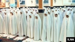 A group of Iranian student praying during school.