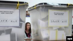 An electoral staff member waits for voters at a polling station in the ethnically divided city of Mitrovica on November 17.