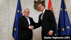 European Commission President Jean-Claude Juncker (left) shakes hands with Serbian President Aleksandar Vucic in Belgrade on February 26.