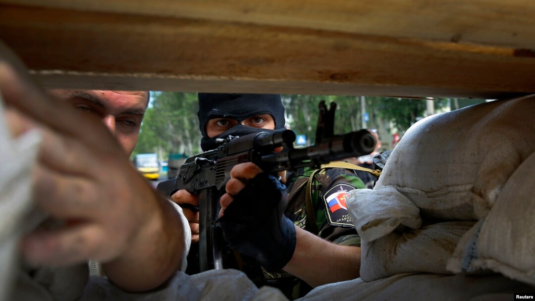 A heavily armed pro-Russian rebel mans a newly erected barricade on the airport road of the eastern Ukrainian city of Donetsk on May 27. 