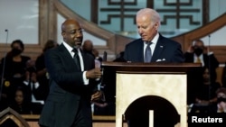 Američki predsjednik Joe Biden pored senatora Raphaela Warnocka, višeg pastora u baptističkoj crkvi Ebenezer, uoči praznika u čast Martina Luthera Kinga Jr., u Atlanti, 15. januara 2023. 