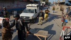 Police stand guard along a road in Bannu. (file photo)
