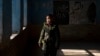 An Afghan schoolgirl stands in an empty classroom in Kabul after the Taliban barred teenage girls from attending secondary school.