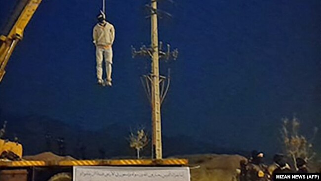 A photo obtained from the Iranian Mizan news agency on December 12 shows the public execution of Majidreza Rahnavard in Iran's Mashhad city, the second capital punishment linked to nearly three months of protests.
