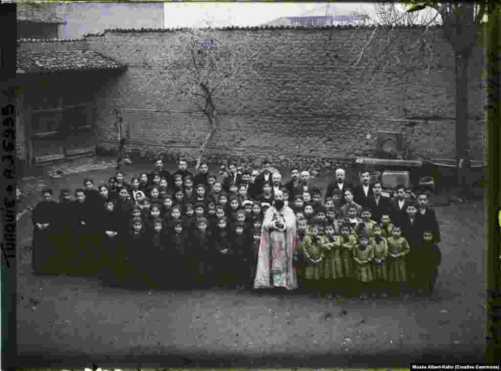 A group of Armenian orphans in Ankara, Turkey, in 1922 photographed with an Armenian Catholic priest.&nbsp; Some small populations of Armenians remained after the World War I-era killings, but further violence followed.&nbsp;