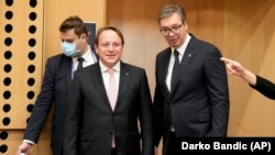 Serbian President Aleksandar Vucic (right) and European Commissioner for Neighborhood and Enlargement Oliver Varhelyi (center) arrive for a roundtable meeting during an EU summit in Kranj, Slovenia in October 2021.
