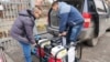 Volunteers load up generators that were purchased thanks to Peykov's fund-raising campaign in Bulgaria.