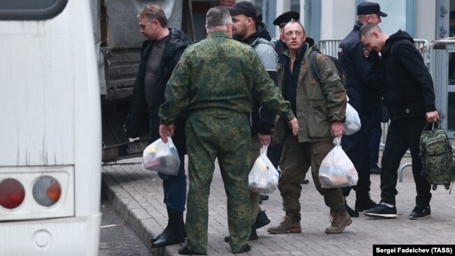 Mobilized men board a bus outside a temporary mobilization station set up at Moscow's Roman Viktyuk Theater at the end of September.