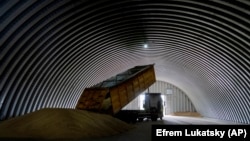 A truck unloads grain in a granary in the village of Zghurivka, Ukraine, on August 9.