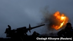 Ukrainian soldiers fire a 2S7 Pion self-propelled cannon during intense shelling on the front line in Bakhmut on December 26.