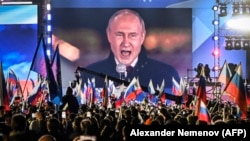 Владимир Путин на экране на Красной площади выступает на митинге и концерте, посвящённых аннексии четырёх регионов Украины, оккупированных российскими войсками. Москва, 30 сентября 2022 года