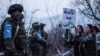 Protesters stand in front of Russian peacekeepers on the road outside Stepanakert, the de facto capital of Nagorno-Karabakh, on December 24, 2022. 