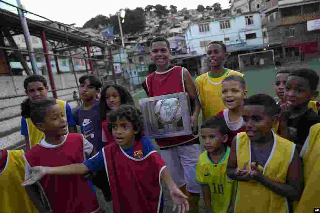 Dječak drži loptu koju je donirao Pele ispred škole fudbala Profesor Mateia u faveli Morro da Mineira, Rio de Janeiro, Brazil, 18. novembar 2022. &quot;Život je prilika. Što ćemo s njim učiniti zavisi o svakome od nas. U pravu smo i u krivu. U pobjedi slavimo. U porazu učimo. Život je uvijek velikodušan i nudi nove početke&quot;, napisao je, između ostalog, Pele u pismu na Instagramu upućenom Brazilcima koji su bili utučeni zbog četvrtfinalnog poraza od Hrvatske na nedavnom Mundijalu u Kataru.