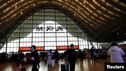 Люди в масках на вокзалі в Китаї, фото ілюстративне