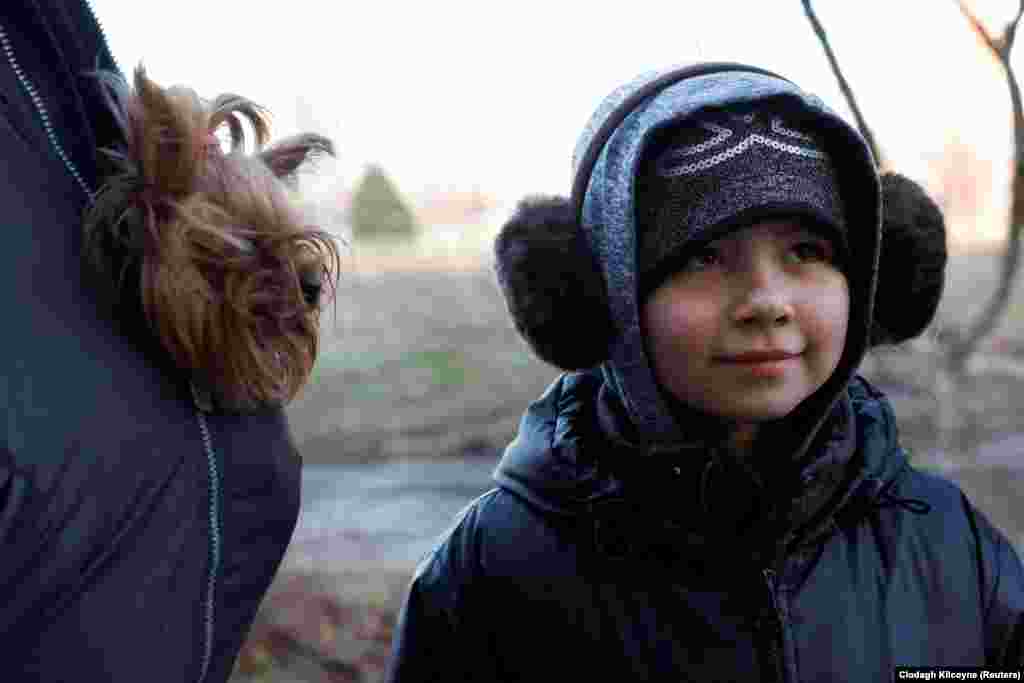 Lyubov, 9, waits her turn with her grandfather. &nbsp;