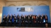 NATO foreign ministers and participants pose for a family photo during a meeting in Bucharest on November 29.