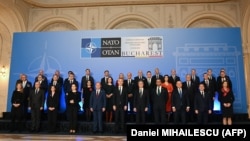NATO foreign ministers and participants pose for a family photo during a meeting in Bucharest on November 29.