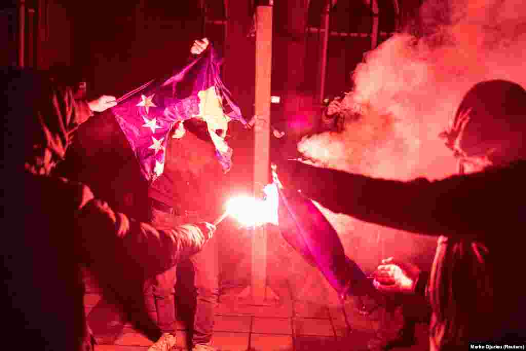 A protester burns a Kosovo flag in Belgrade on December 12. EU foreign policy chief Josep Borrell has called for de-escalation from both Kosovo and Serbia, while Serbian&nbsp;President Aleksandar Vucic has called for the deployment of Serbian troops to northern Kosovo, fueling fears of a new war.